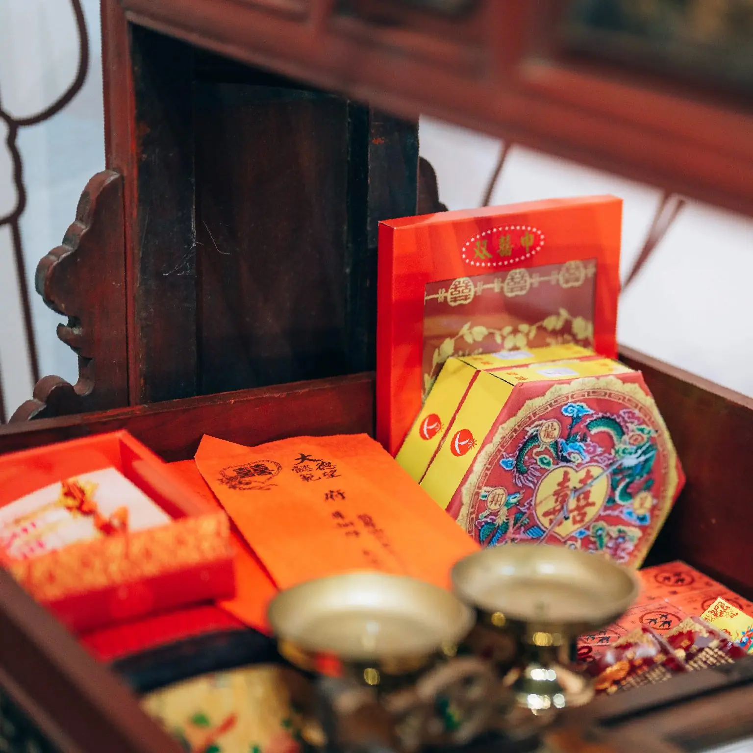 Close-up of dowry gift boxes and red envelopes and other wedding tokens